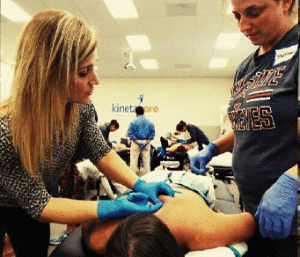 JJ Thomas teaching young physical therapist student how to use dry needling