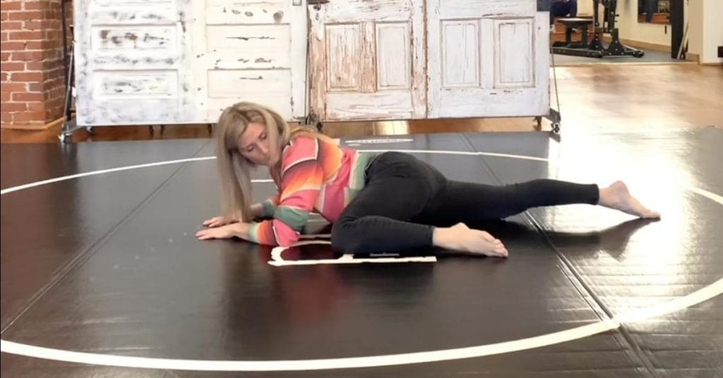 a woman performing a repetitive straing injury stretching exercise on the floor