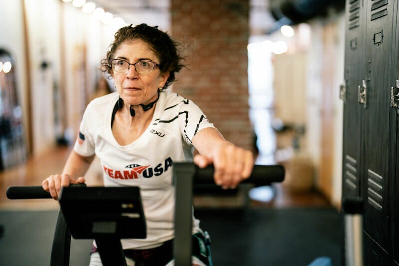 patient exercising on stationary bike during physical therapy recovery